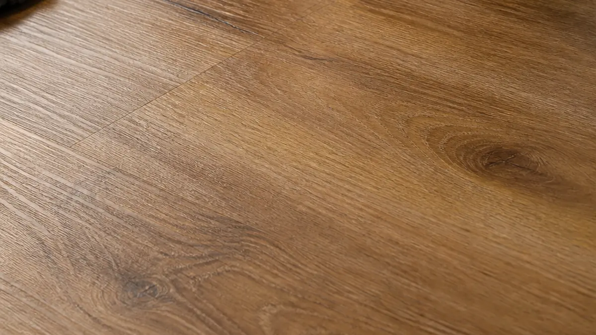 close-up editorial shot of EIR SPC flooring plank surface showing grain texture aligned with printed wood design, professional studio lighting